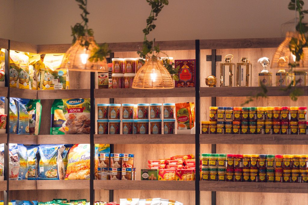 Prashad Café Indian grocery shelves with spices, flours and pickles